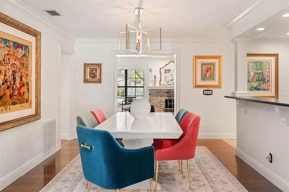 The foyer of 221 Minnehaha, with hardwood floors, a custom built-in library, and sightlines through to the dining room